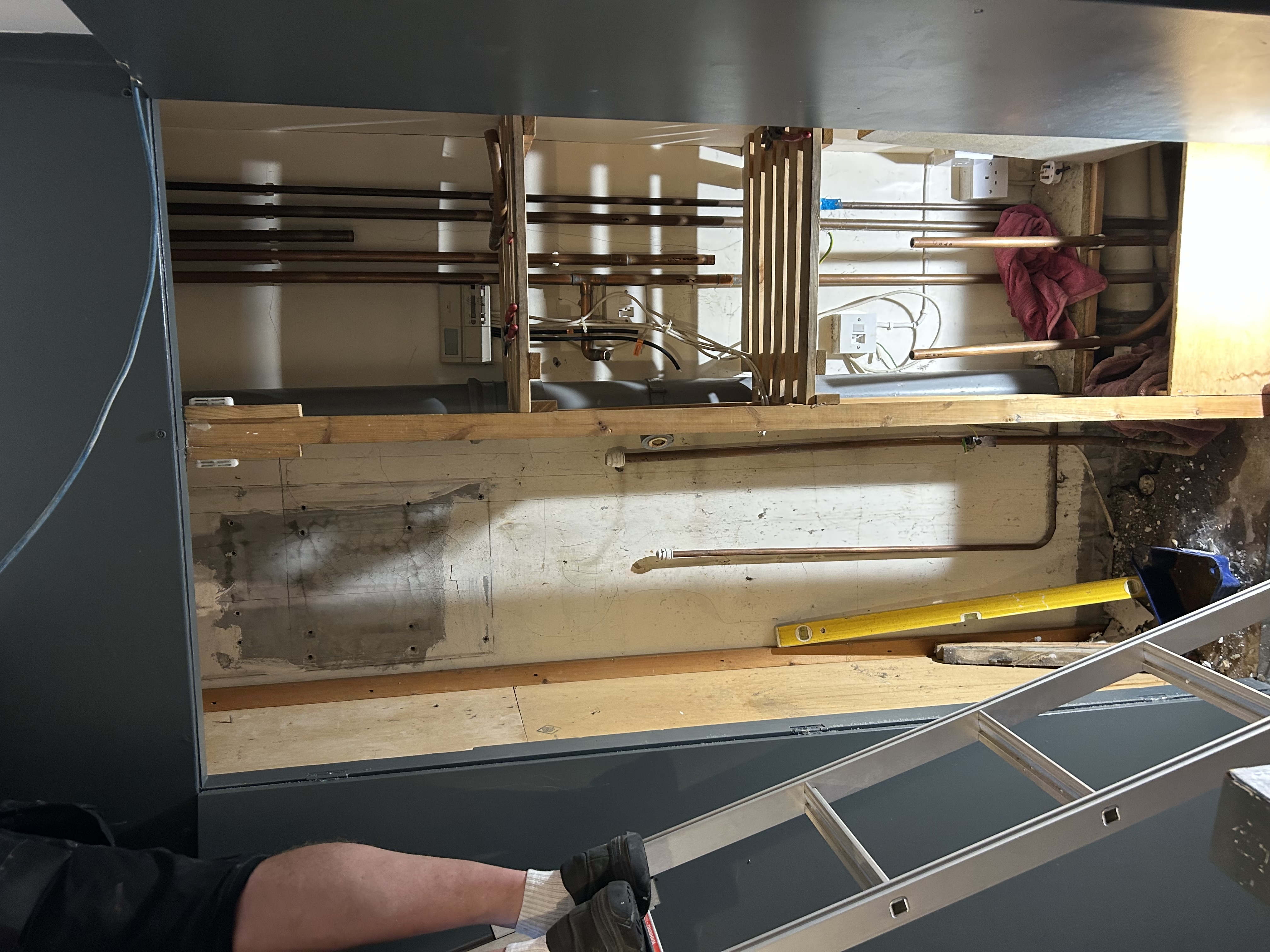 Airing cupboard during boiler replacement showing existing heating pipework in Sevenoaks