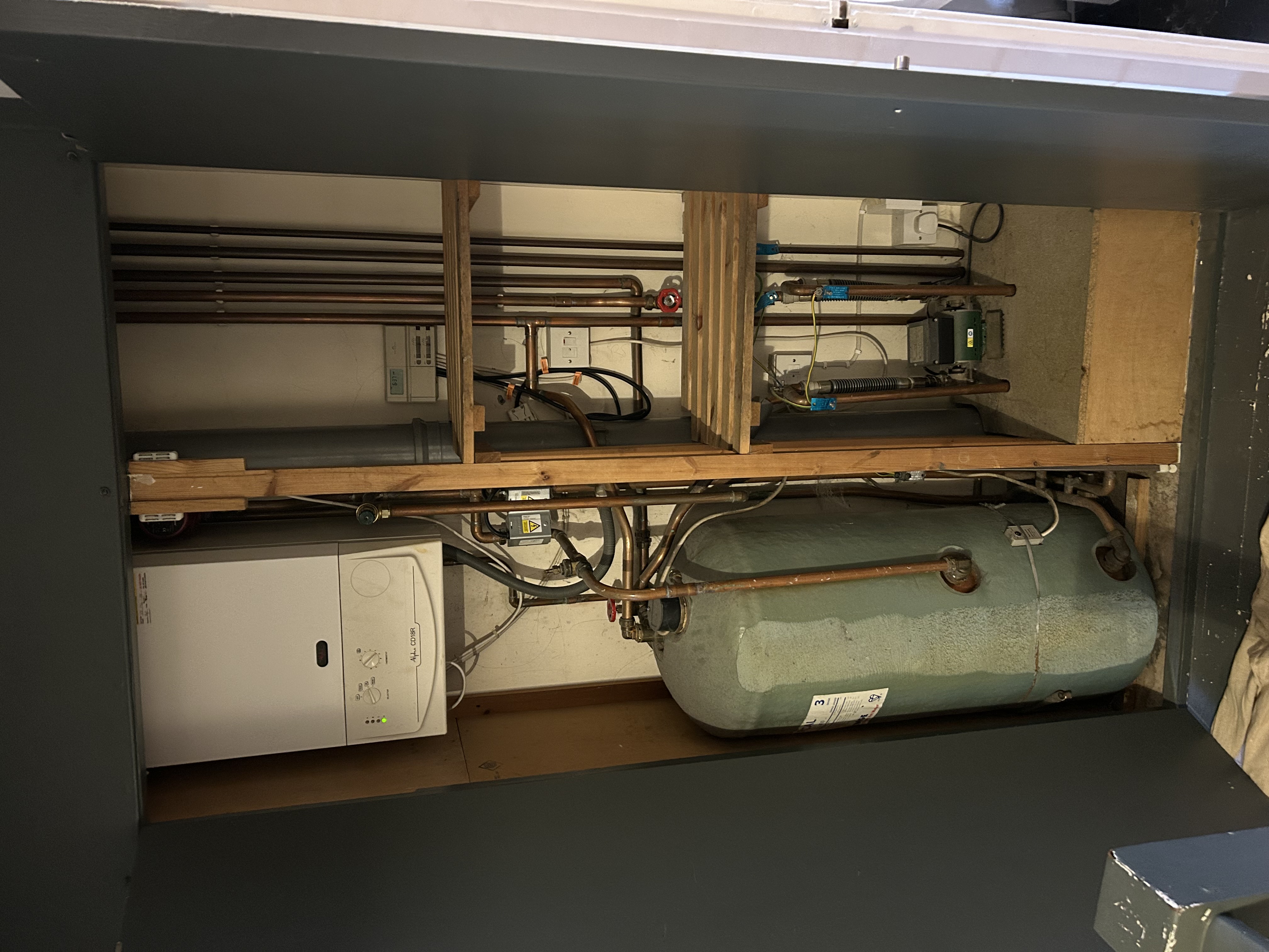 Existing Alpha CD18R boiler and hot water cylinder in airing cupboard before replacement in Sevenoaks